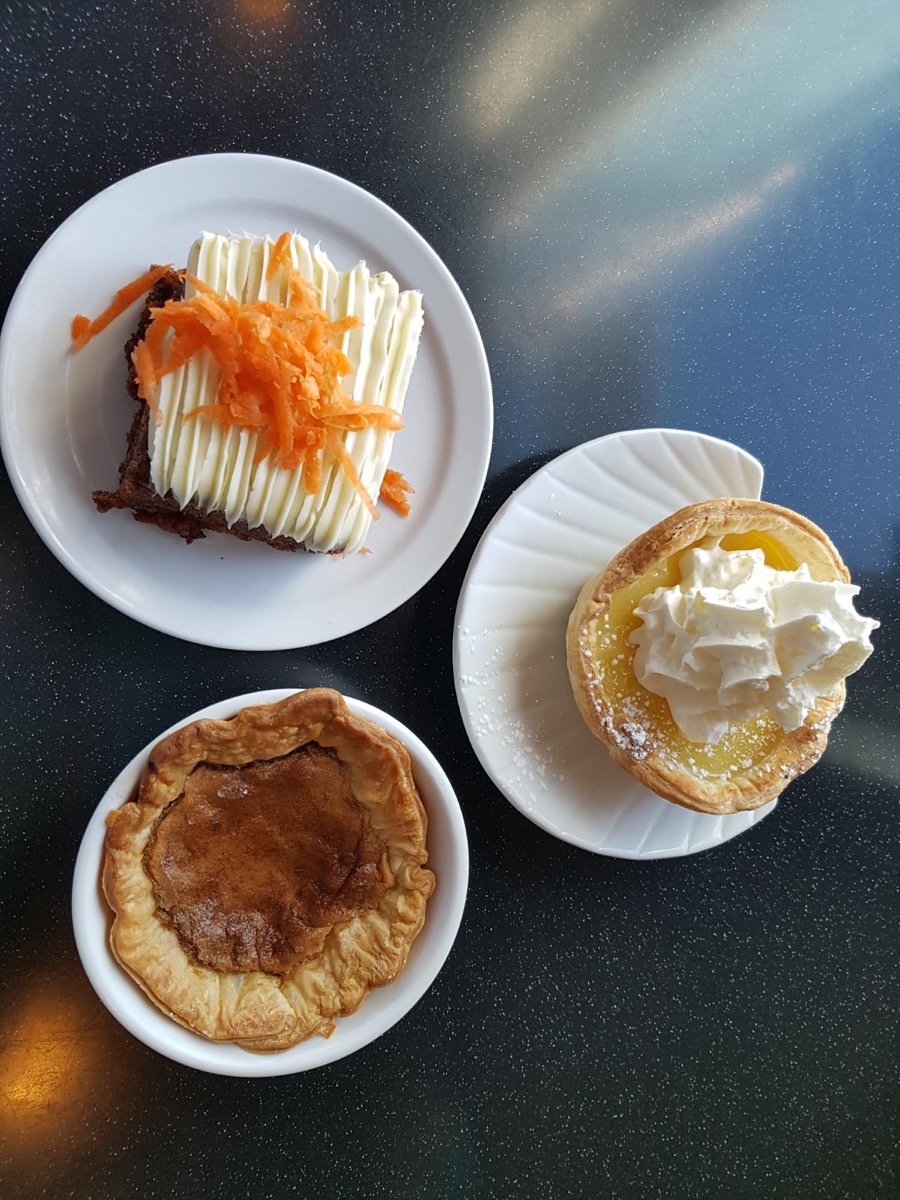 Three desserts including pie and a whipped cream tart.